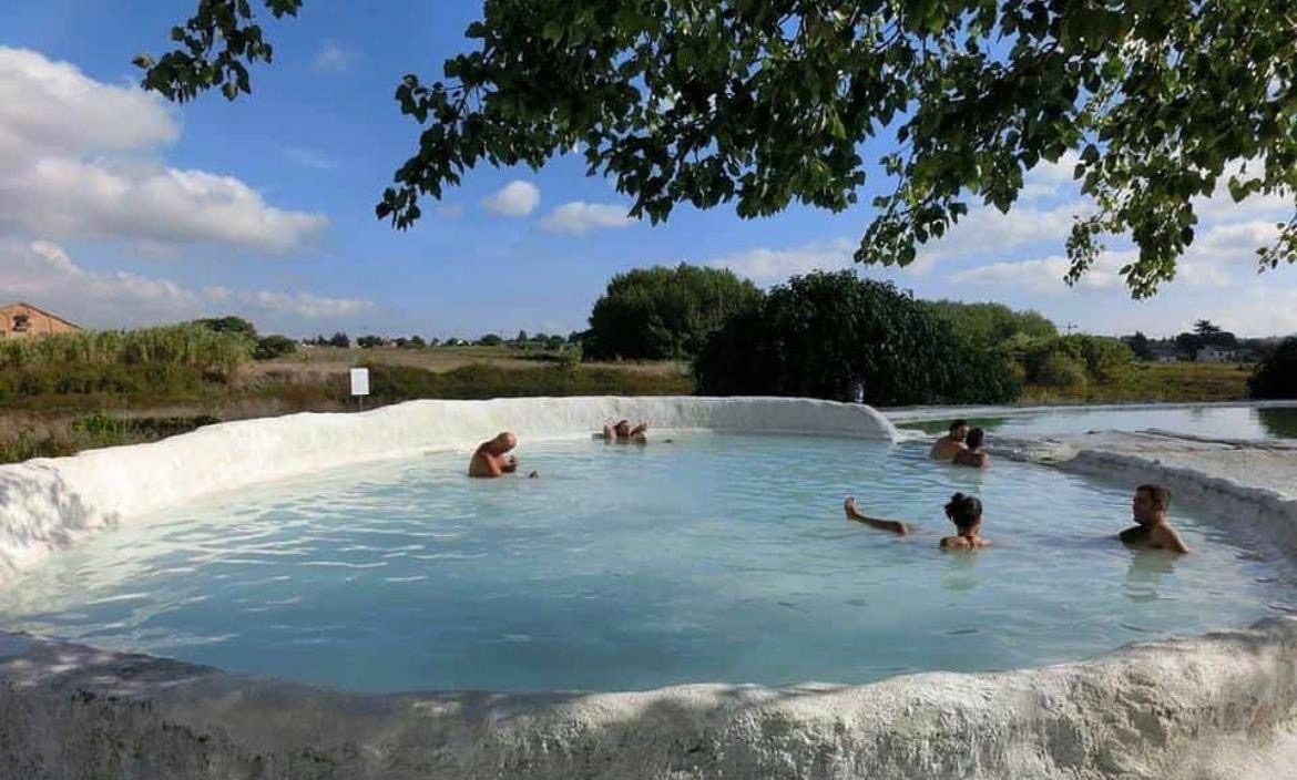 Open-air thermal pool with white mineral edges